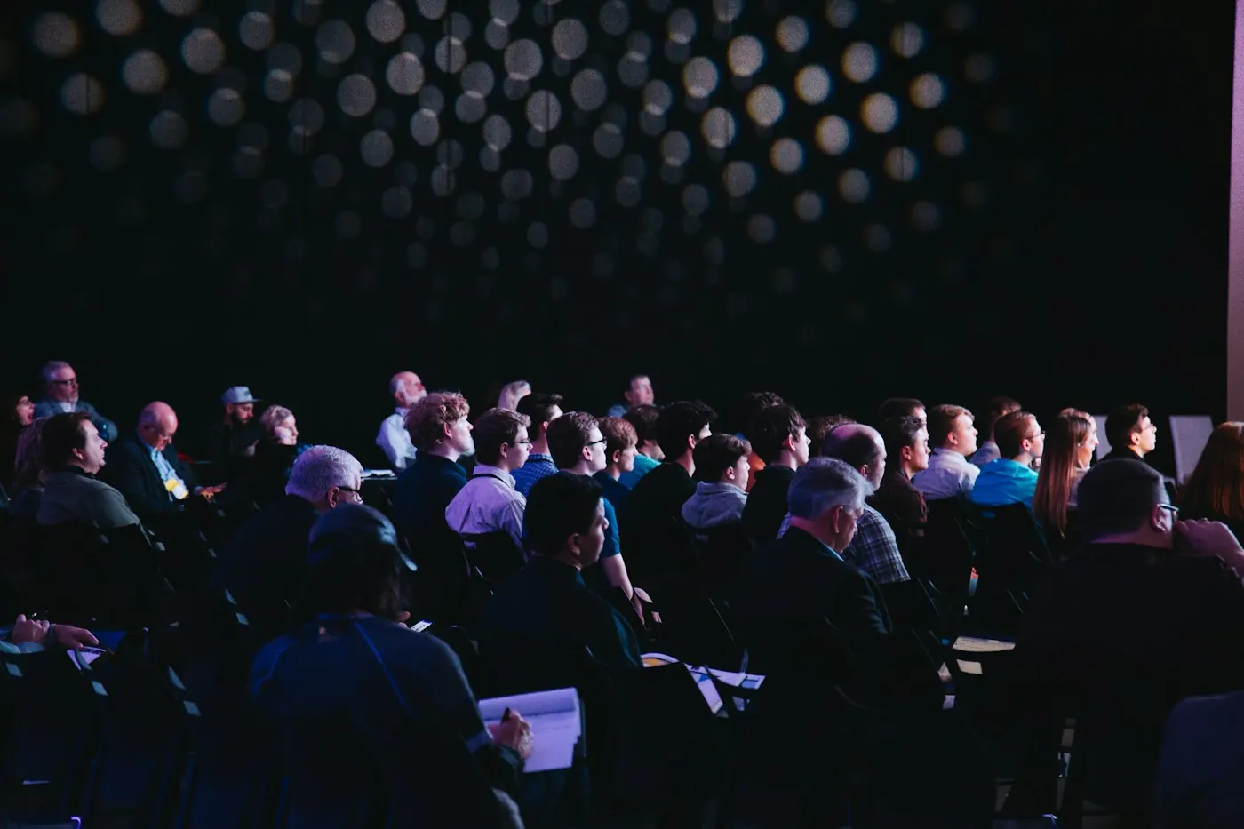 Attendees seated together at a professionally lit conference