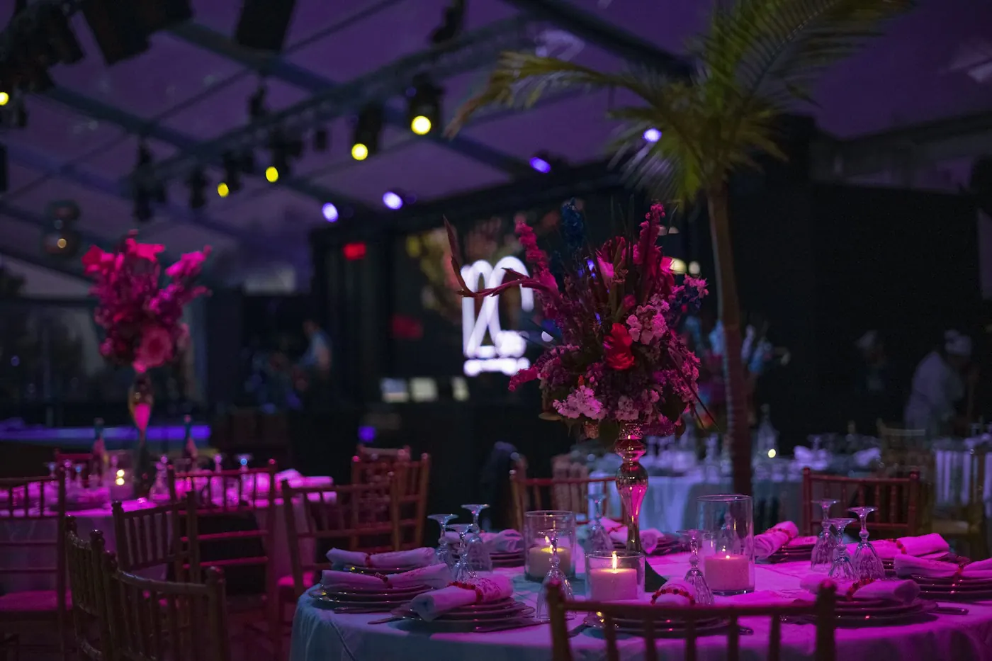 Event tables under theatrical purple lighting