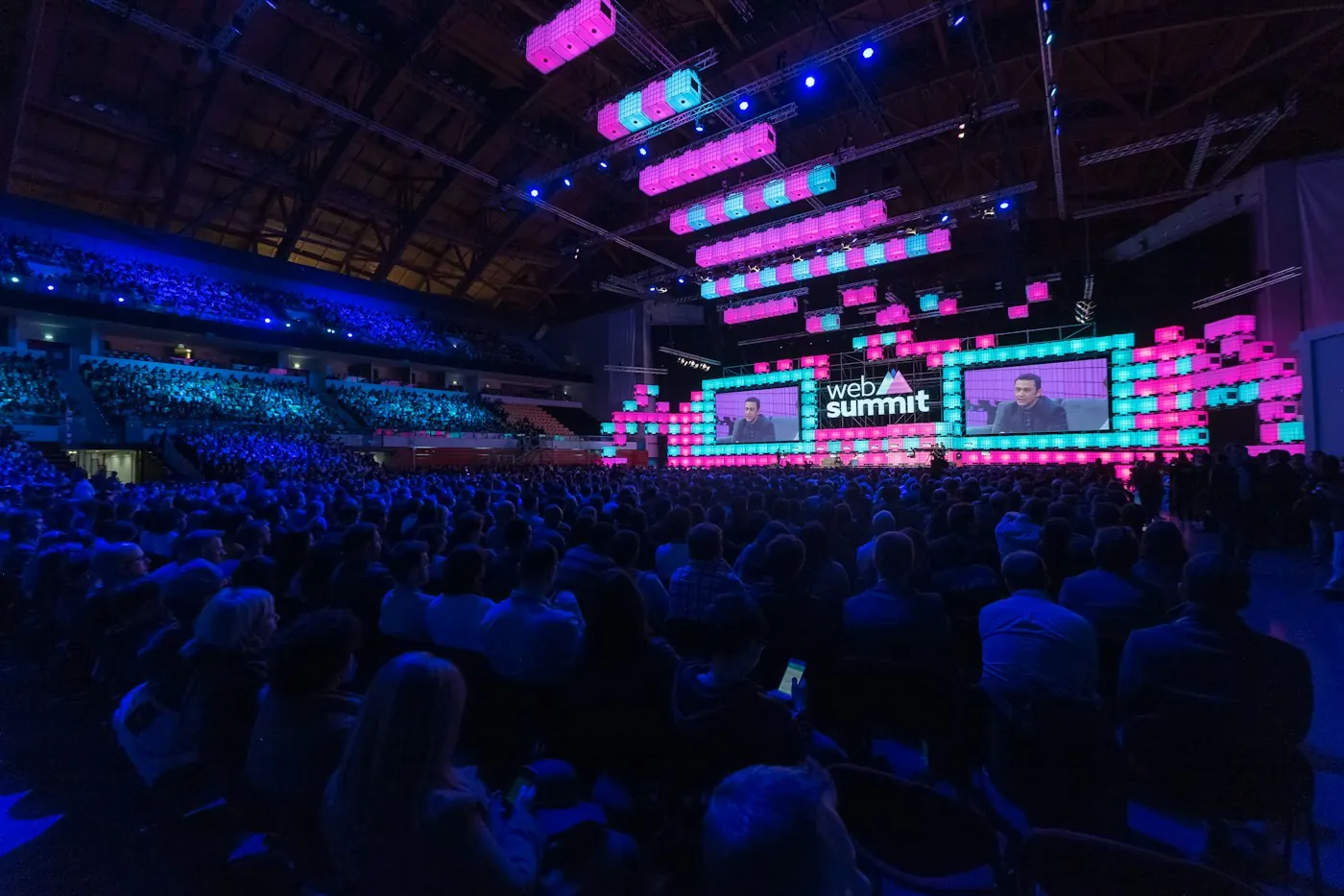 Large stage with purple lighting and a big audience