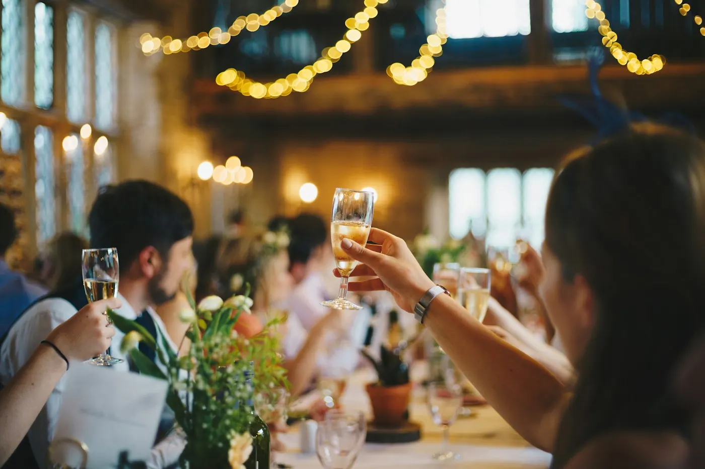 Guests raising glasses around a celebration table