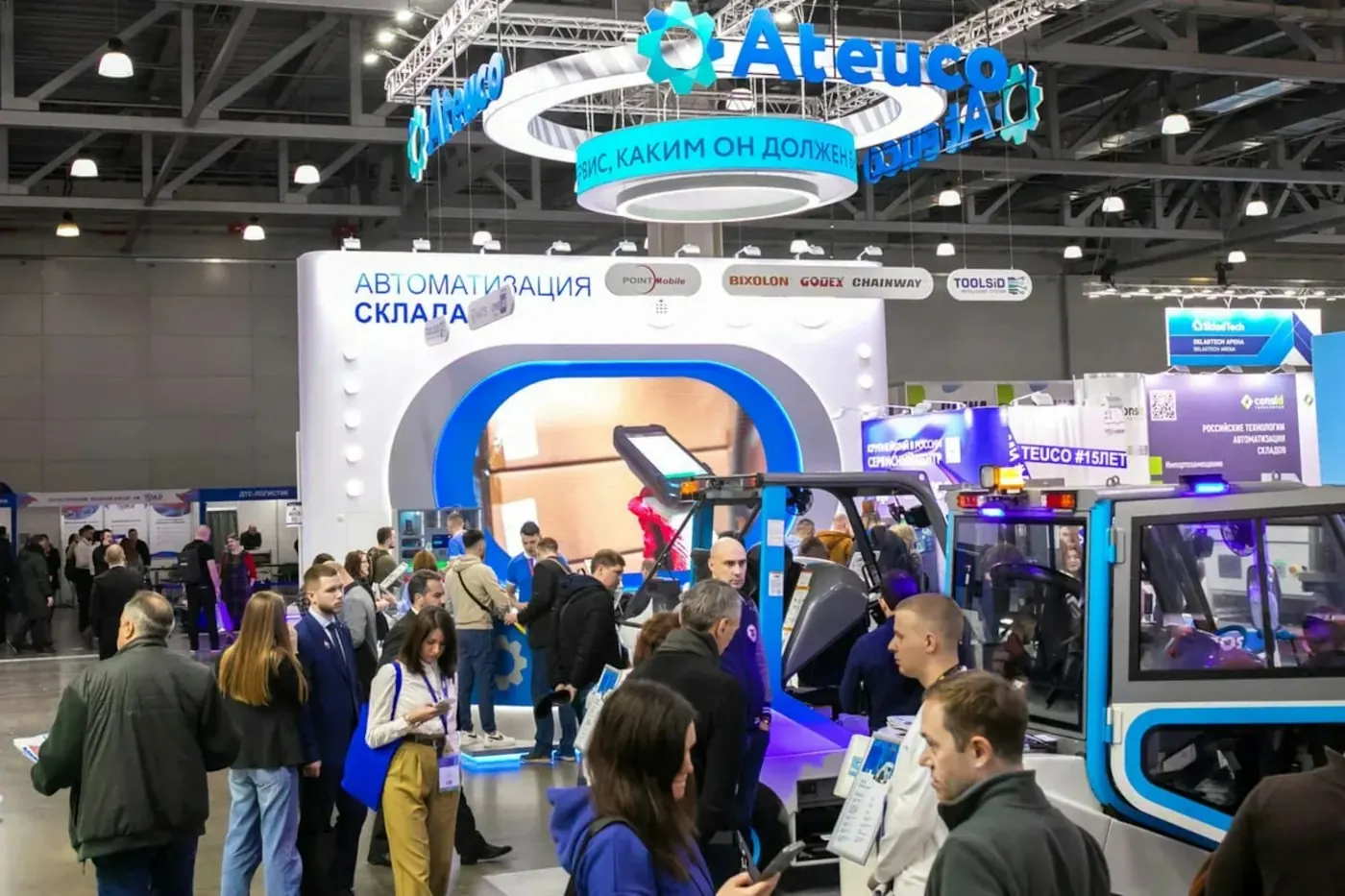 Busy trade show floor with large booth displays